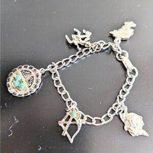 Silver tone with turquoise colored accents charm bracelet